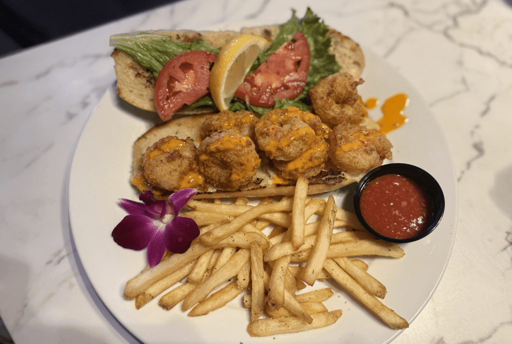 Shrimp po’ boy sandwich with jumbo shrimp, lettuce, tomato, and fries served at Fish Tale Grill in Cape Coral.
