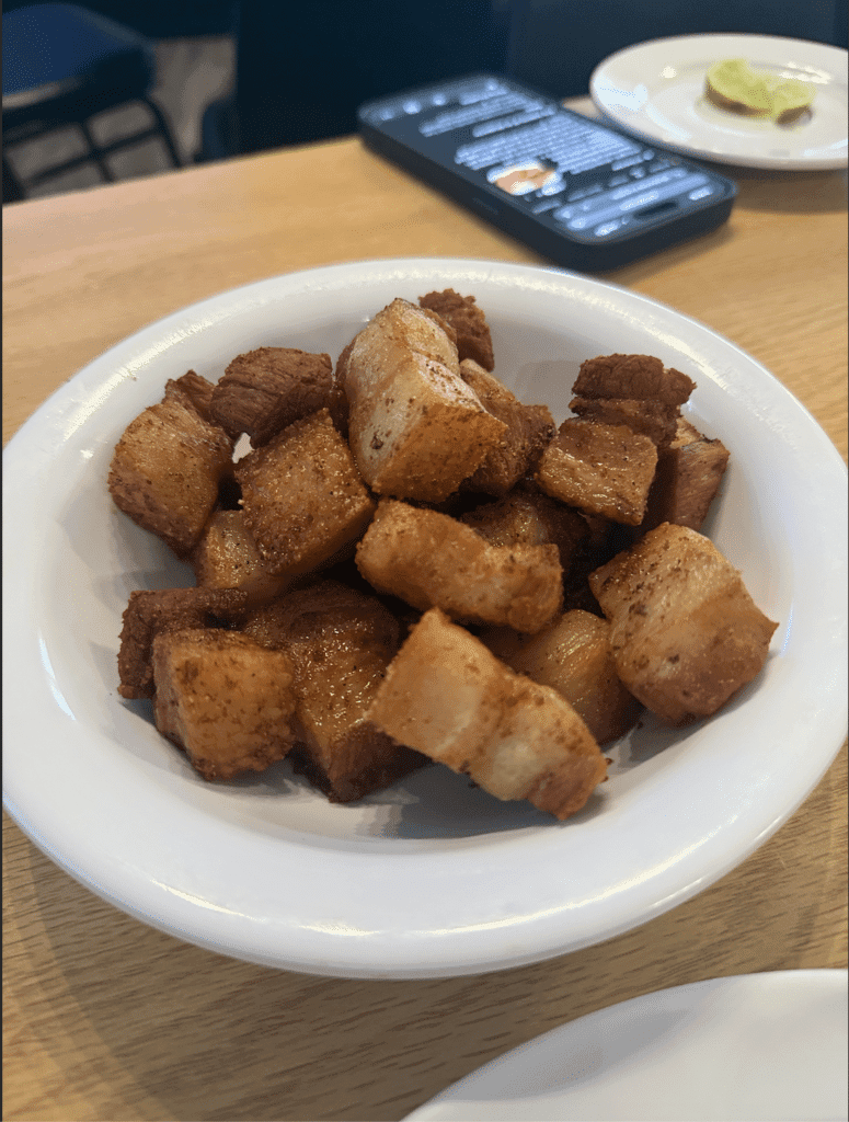 Crispy chicharrón de cerdo made from seasoned pork belly, a traditional Puerto Rican cuisine favorite.