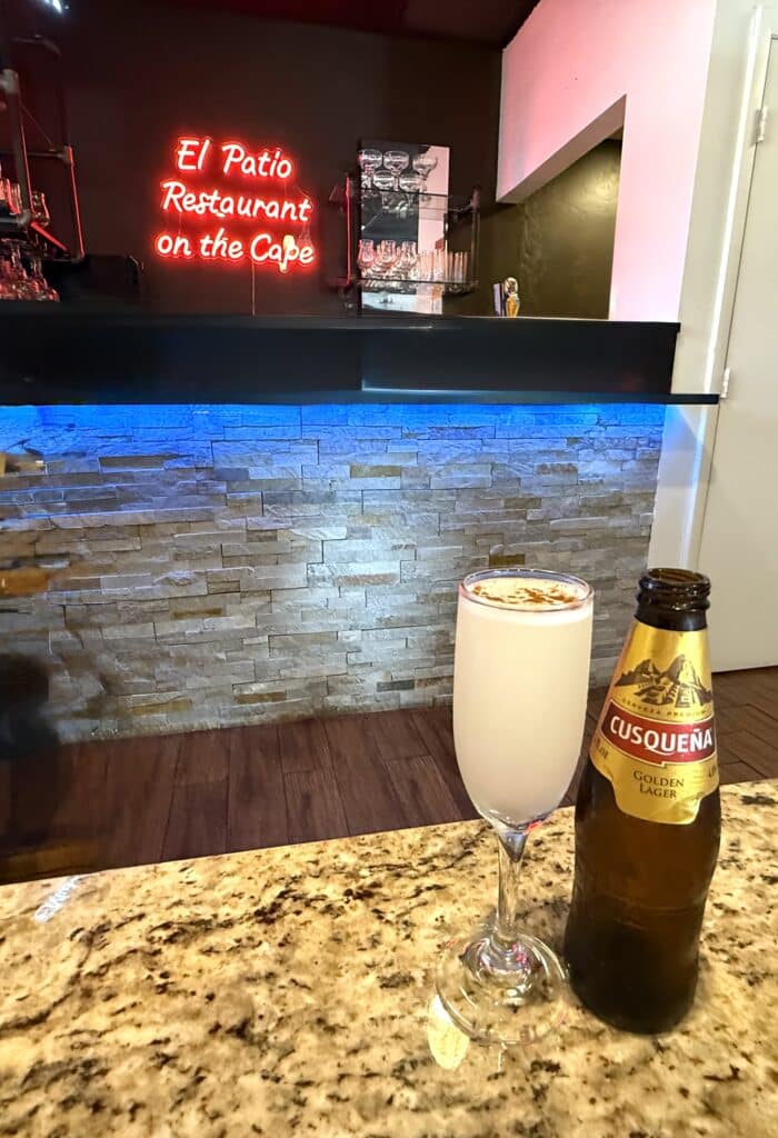 A margarita and Cusqueña beer with El Patio Peruvian Restaurant sign in the background in Cape Coral.