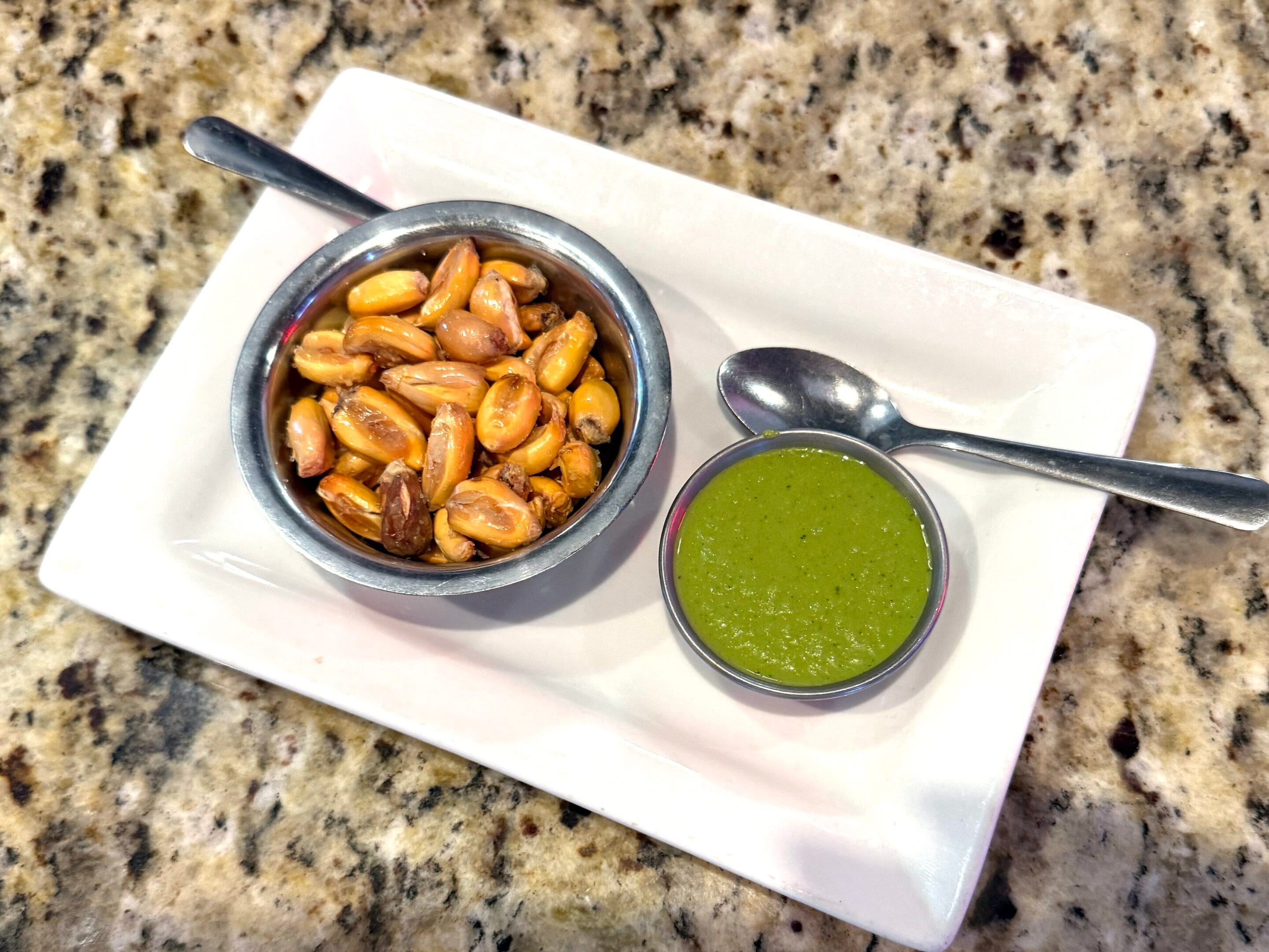 Peruvian fried rice and golden Choclo corn with spicy green sauce at El Patio Peruvian Restaurant in Cape Coral.