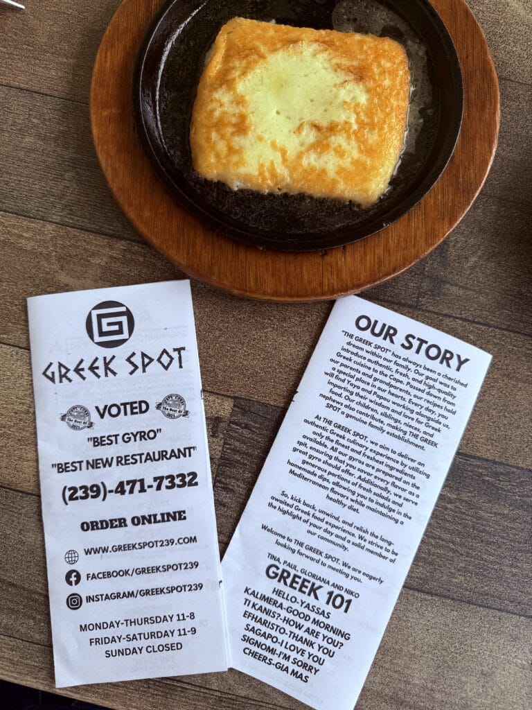 The Greek Spot newspaper-style menu front and back.