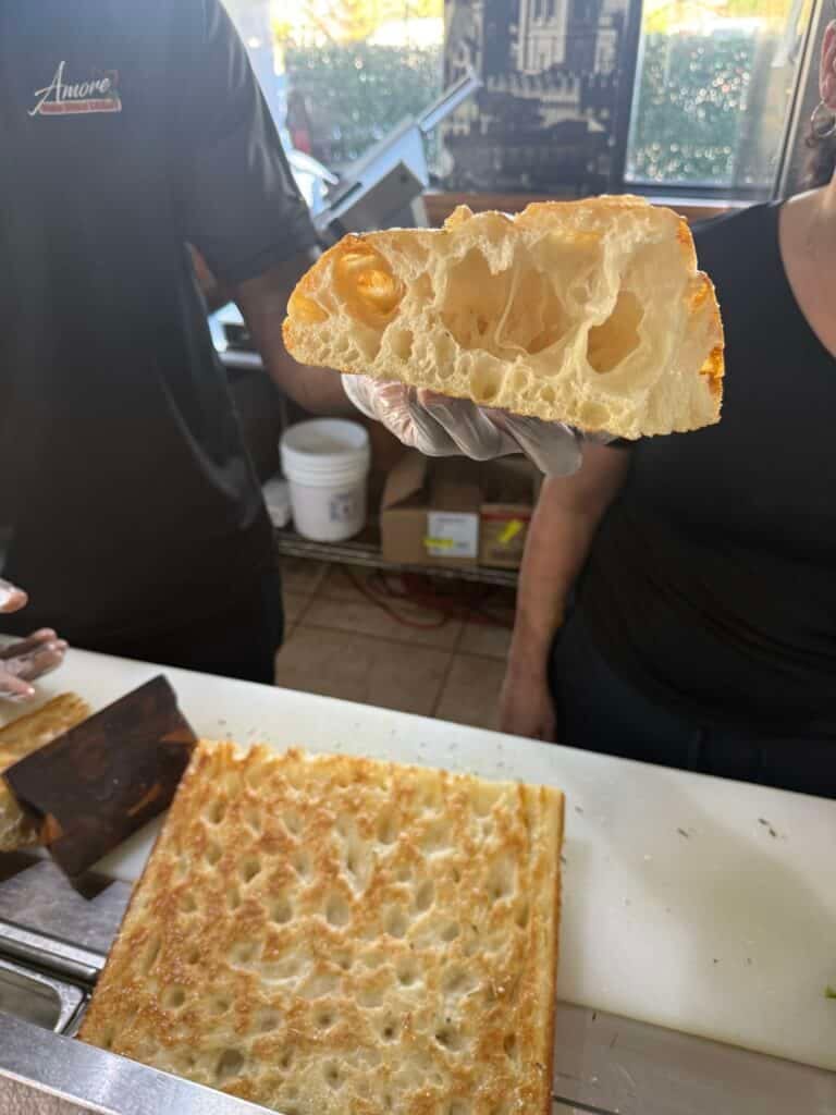 Fresh baked focaccia bread showing airy interior at the Amore Italian Market And Bakery in Cape Coral.