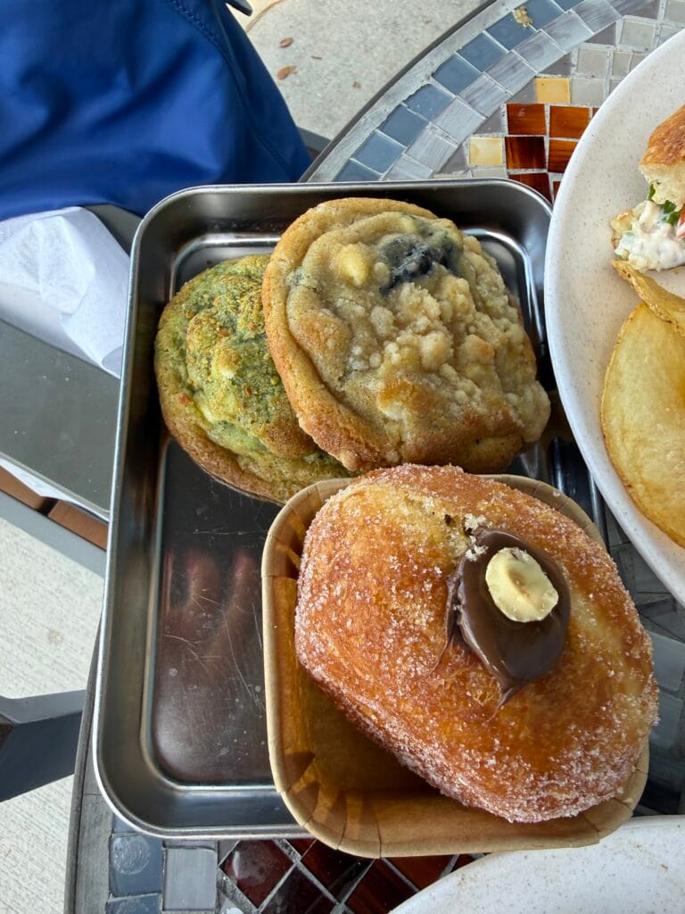 Assorted Italian pastries including a cream-filled donut at Amore Italian Market And Bakery.