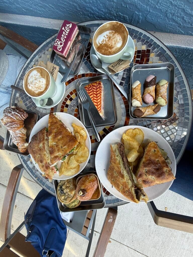 Breakfast spread with cappuccino, Italian pastries and focaccia sandwiches from Amore Italian Market And Bakery.