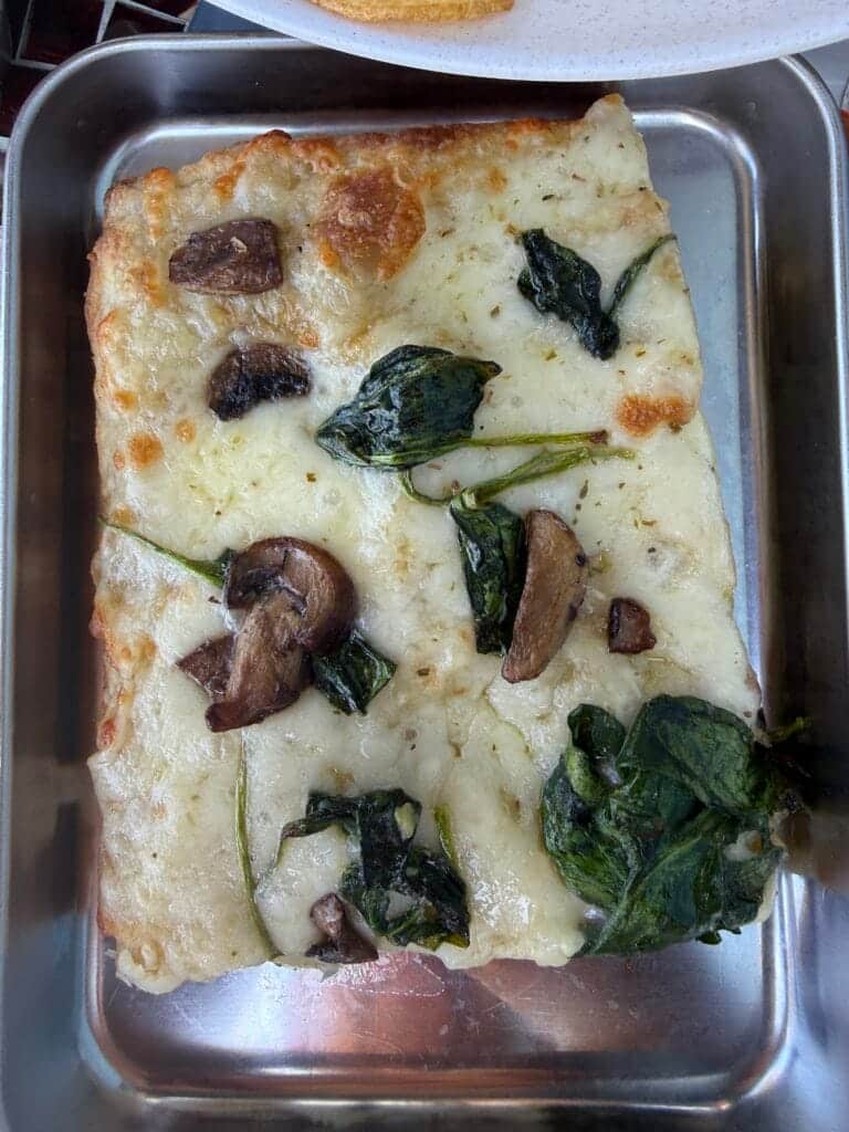 Fresh focaccia bread with mushrooms and greens from Amore Italian Market And Bakery.