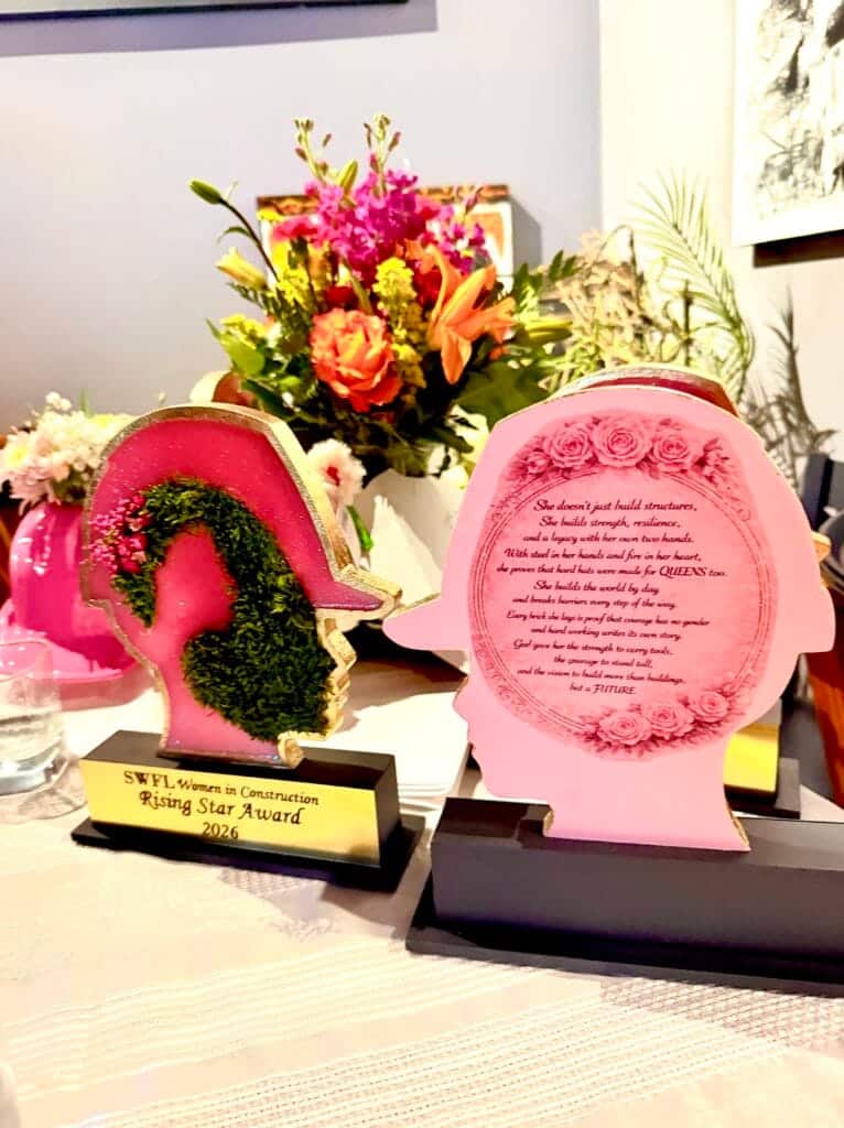 SWFL Women in Construction Rising Star Award displayed with flowers at Women in Construction Week celebration event.