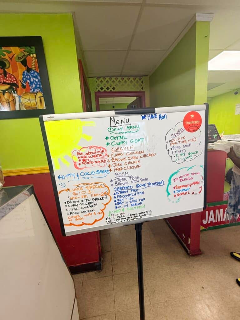 Menu board inside Manda’s Jerk Chicken in Cape Coral featuring Jamaican dishes and daily specials