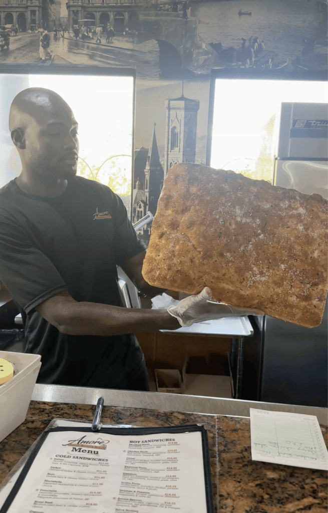 Fresh gluten-free focaccia bread prepared at the Amore Italian Market And Bakery deli counter.