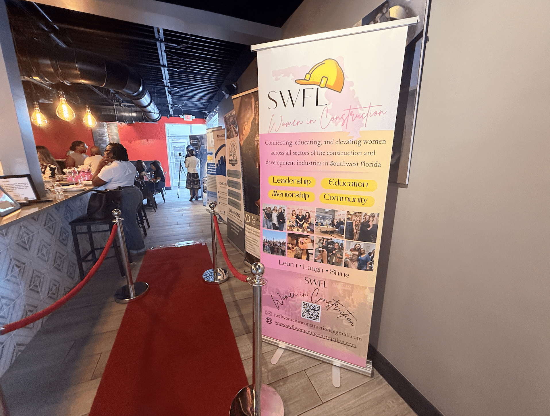 Entrance walkway sign welcoming guests to the Southwest Florida Women in Construction Week event.