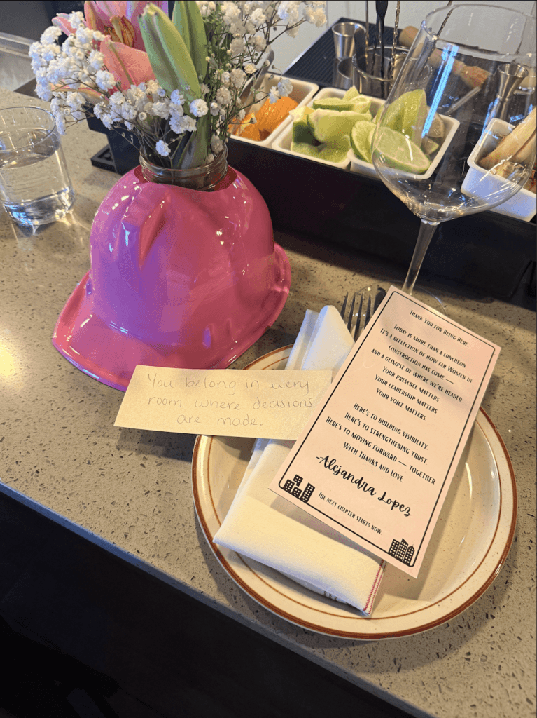 Pink construction hard hat centerpiece and place setting at SWFL Women in Construction Week networking luncheon.