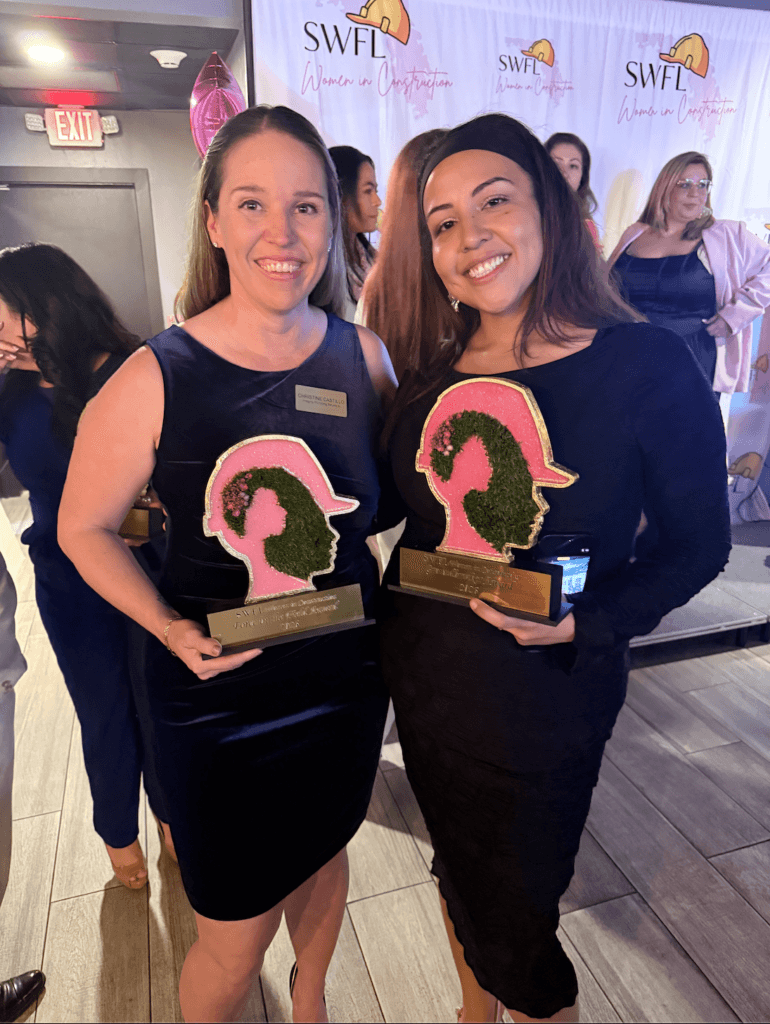 Two professionals holding Rising Star awards during the SWFL Women in Construction Week event celebrating women leaders in the construction industry.
