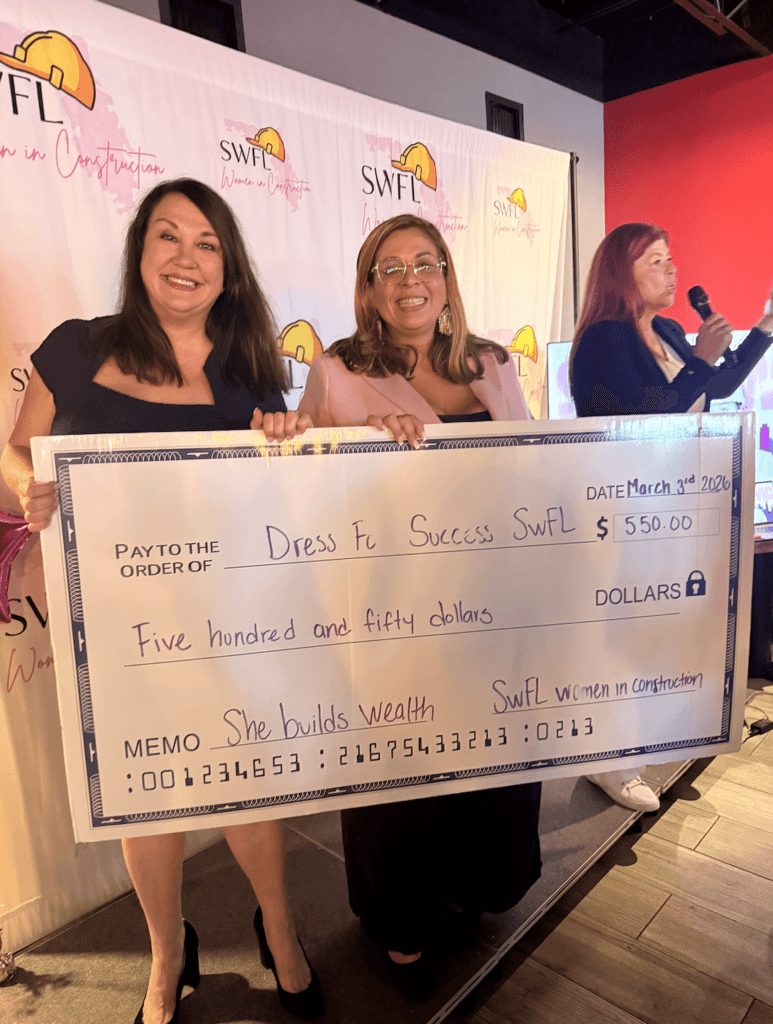 SWFL Women in Construction presenting a donation check to Dress for Success during Women in Construction Week community event.